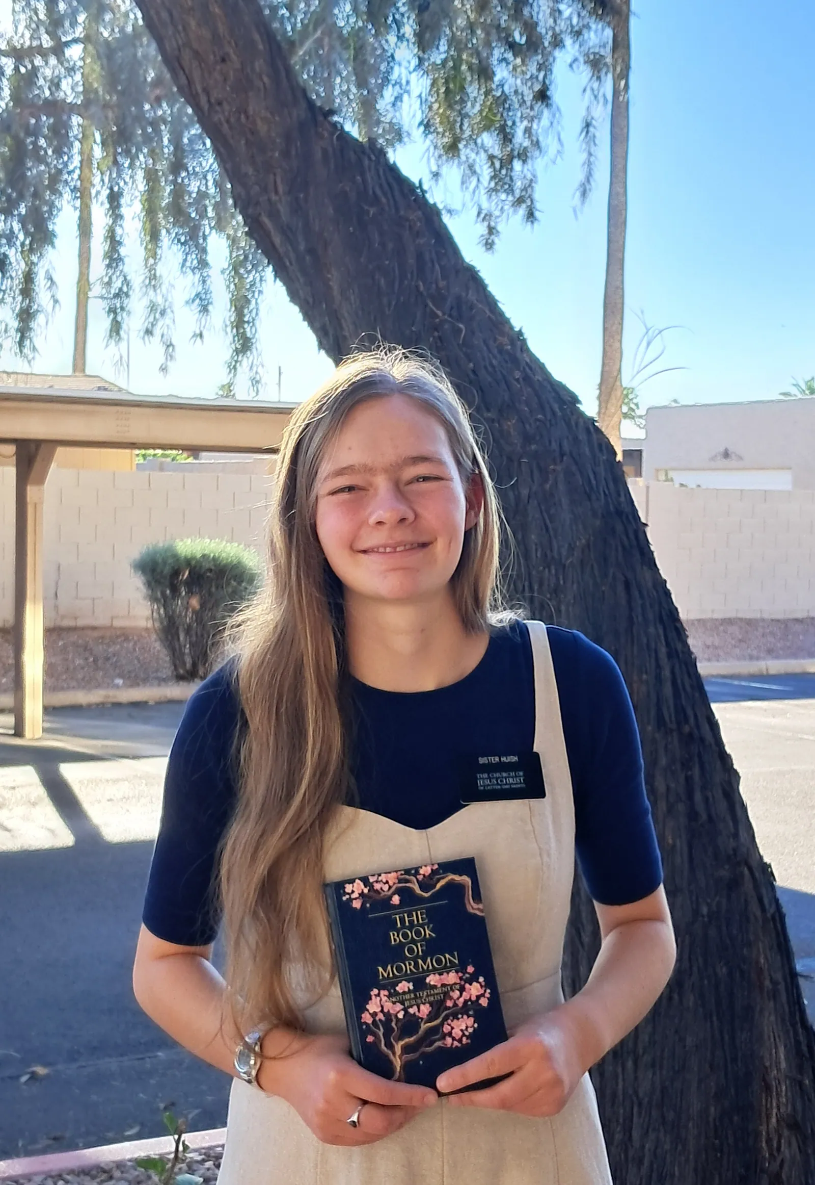 Sister Huish holding her painted Book of Mormon